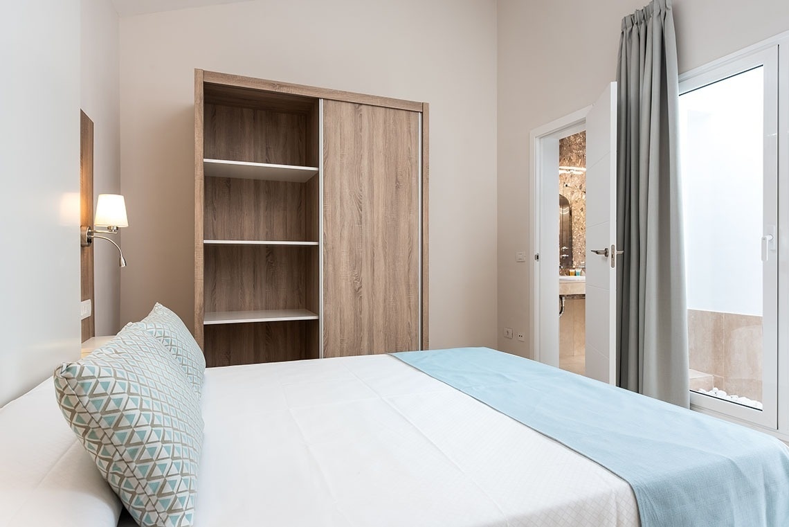 a bedroom with a bed and a closet with sliding doors