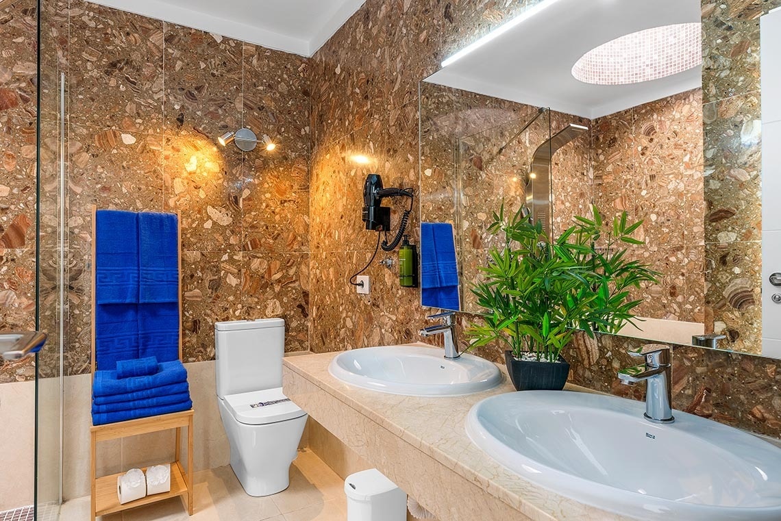 a bathroom with two sinks and a toilet