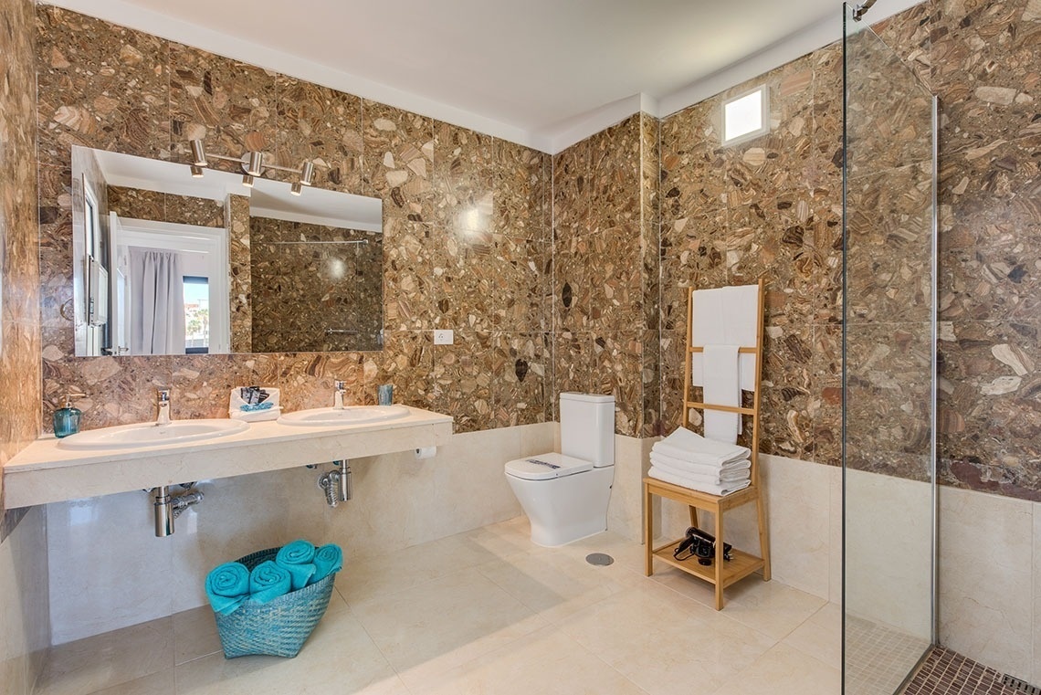 a bathroom with two sinks and a toilet