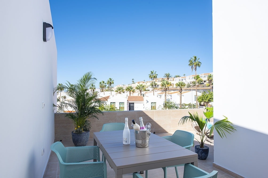 a table with two bottles of wine and a bucket of ice on it