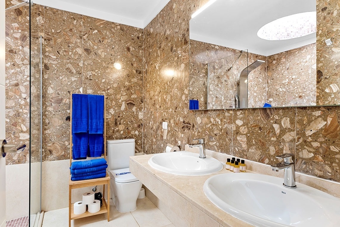 a bathroom with two sinks and a toilet