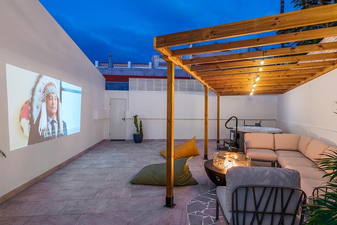 a projector screen shows a picture of a man in a native american headdress