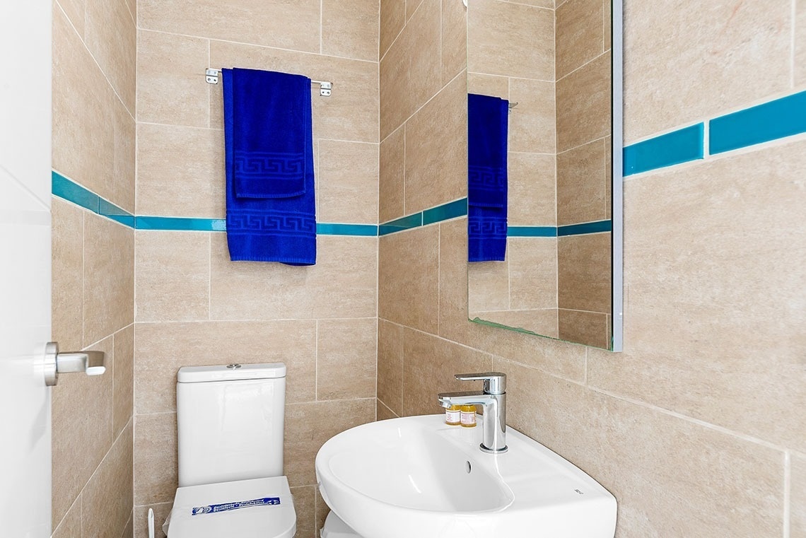 a bathroom with a toilet a sink and a mirror