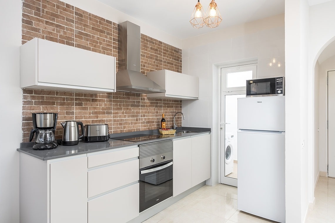 a kitchen with a white refrigerator and a microwave