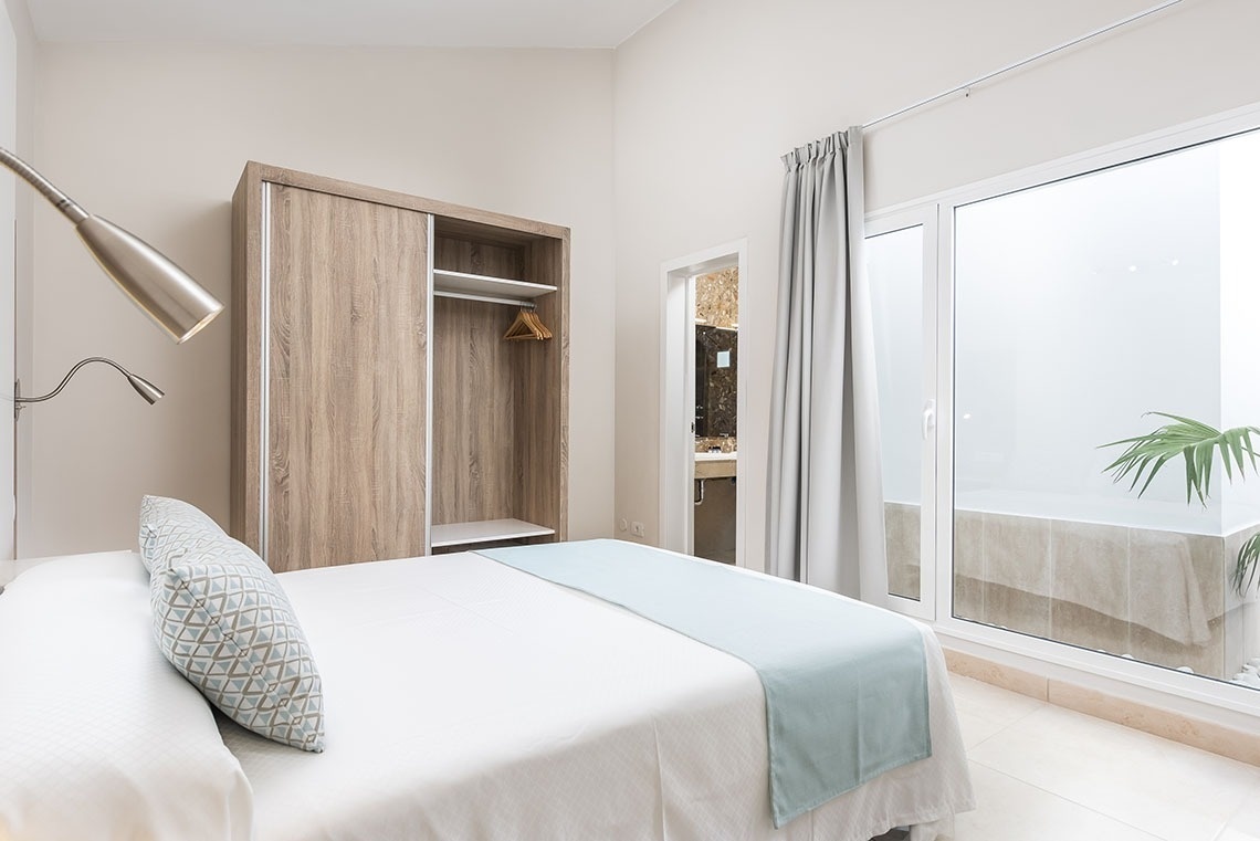 a bedroom with a bed and a sliding glass door