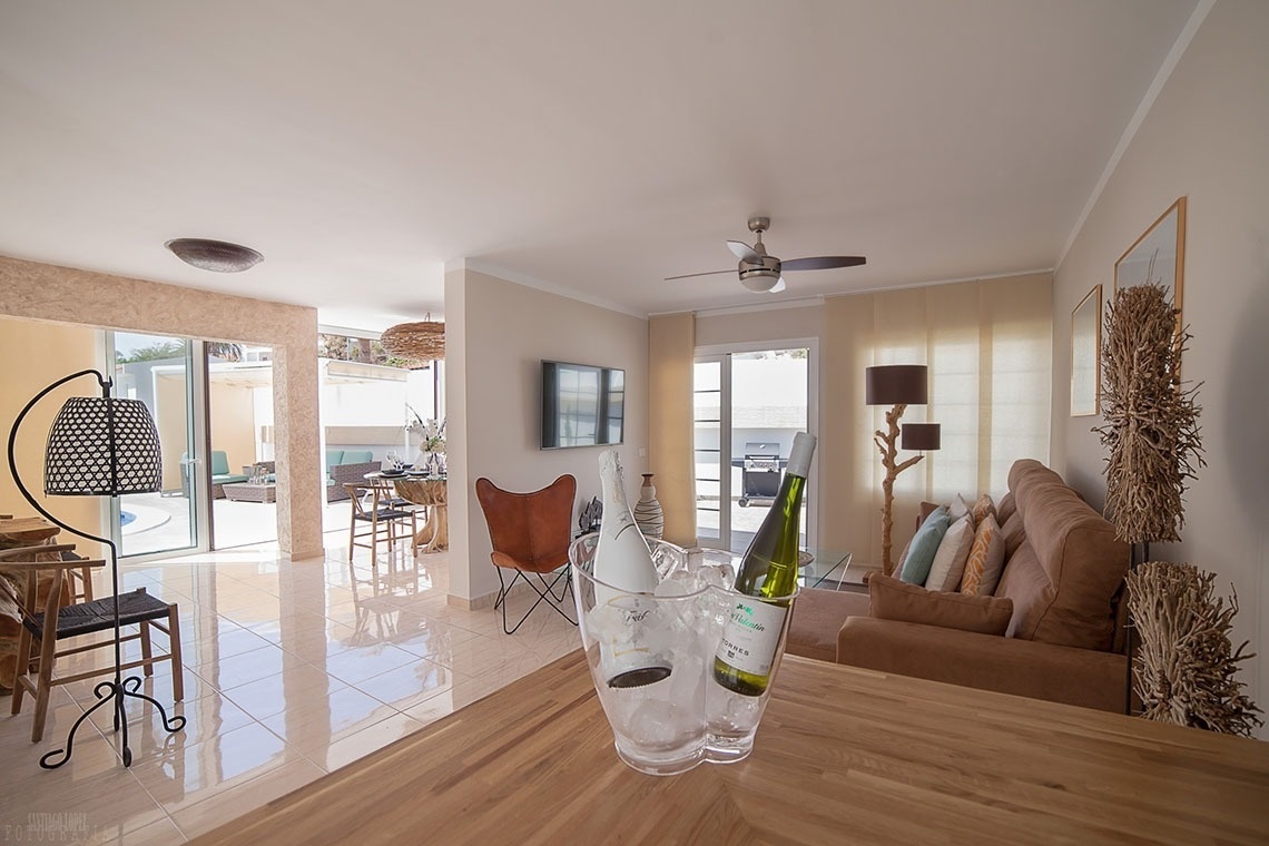 a bottle of wine sits in an ice bucket in a living room