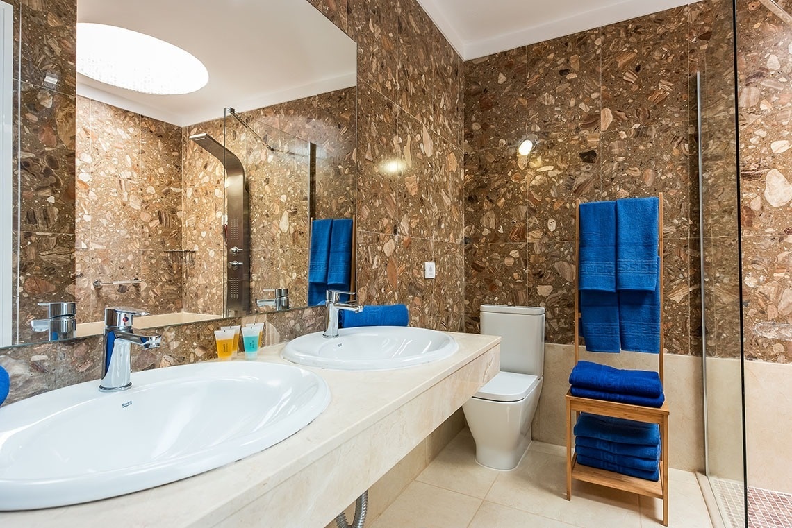 a bathroom with two sinks and a toilet