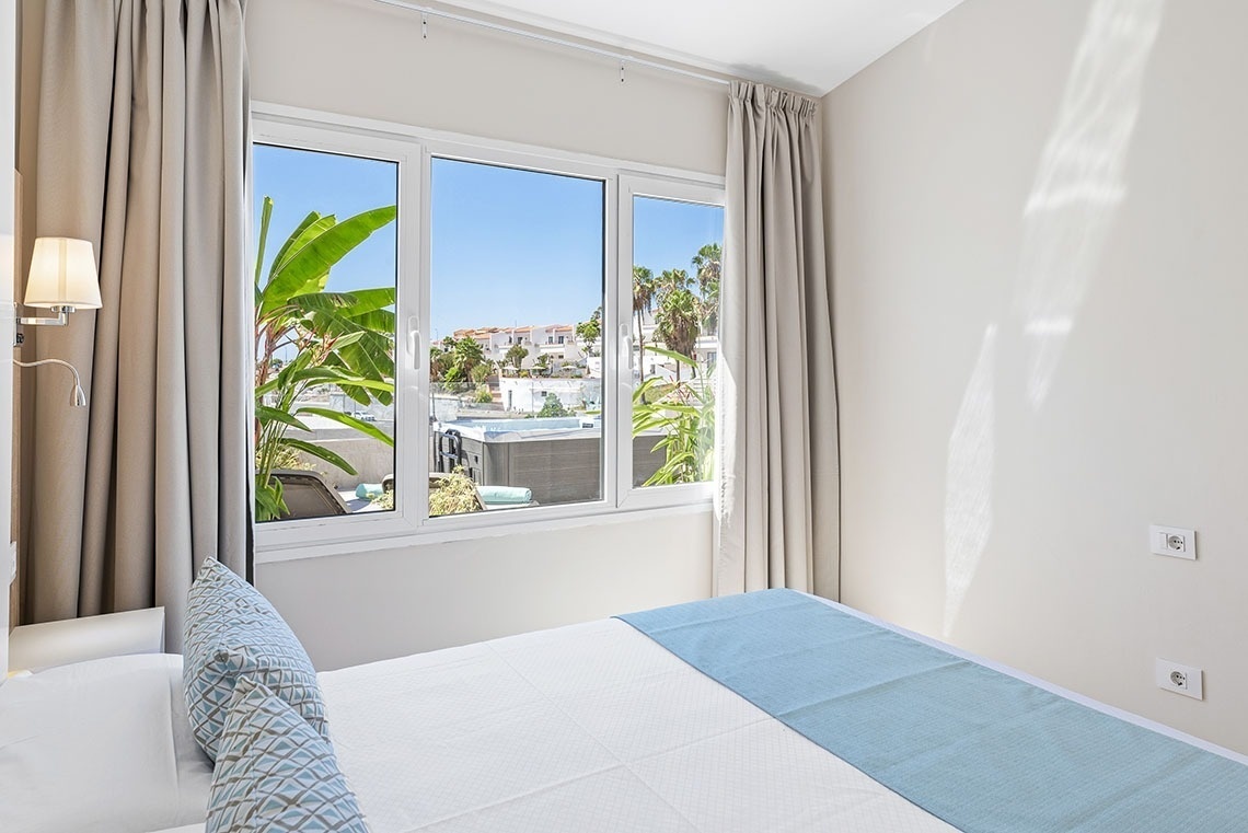 a hotel room with a bed and a large window
