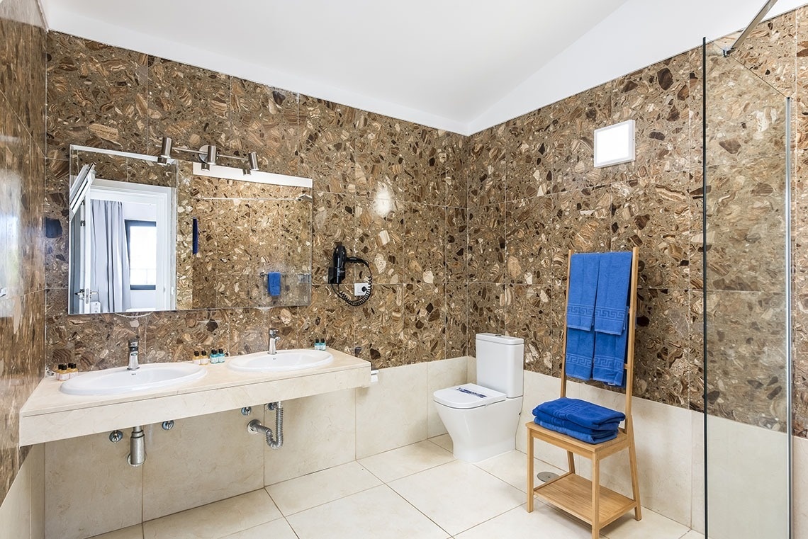 a bathroom with two sinks and a toilet