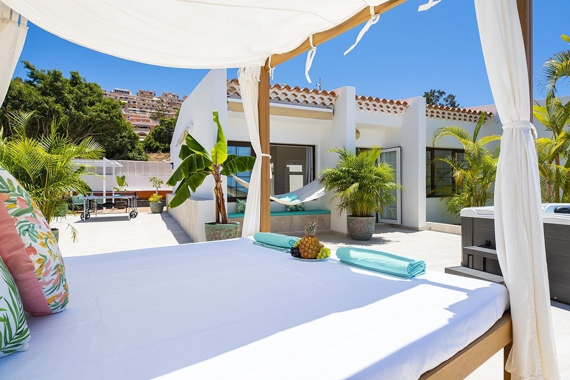 a canopy bed with a hammock and a pineapple on it