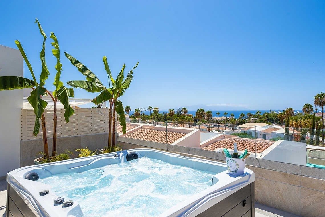 a hot tub with a bucket of champagne in it