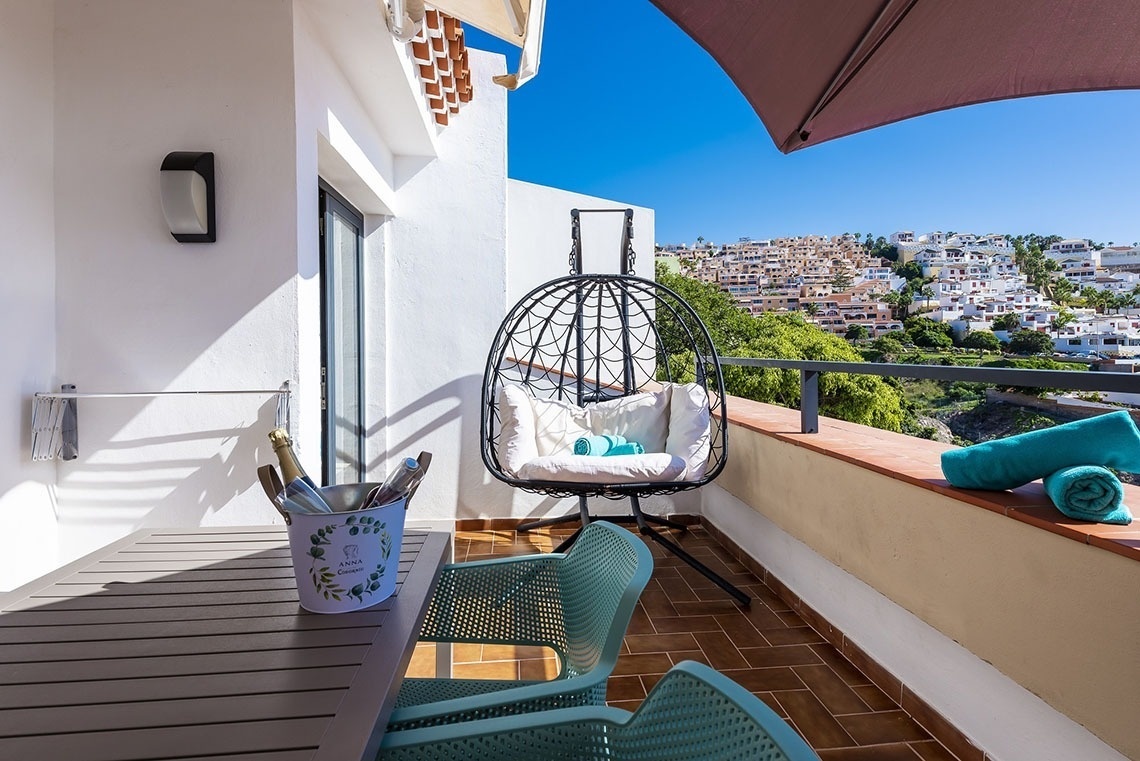 a balcony with a chair and a bucket that says ' a ' on it