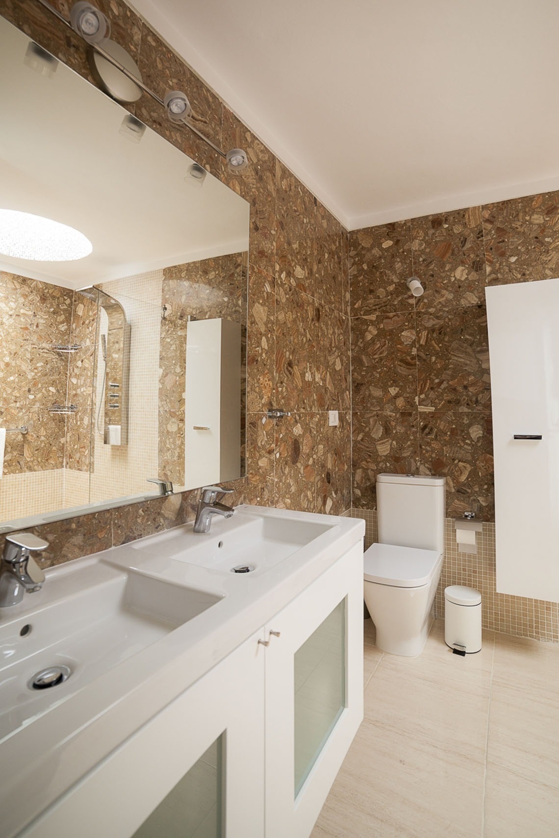 a bathroom with two sinks and a toilet