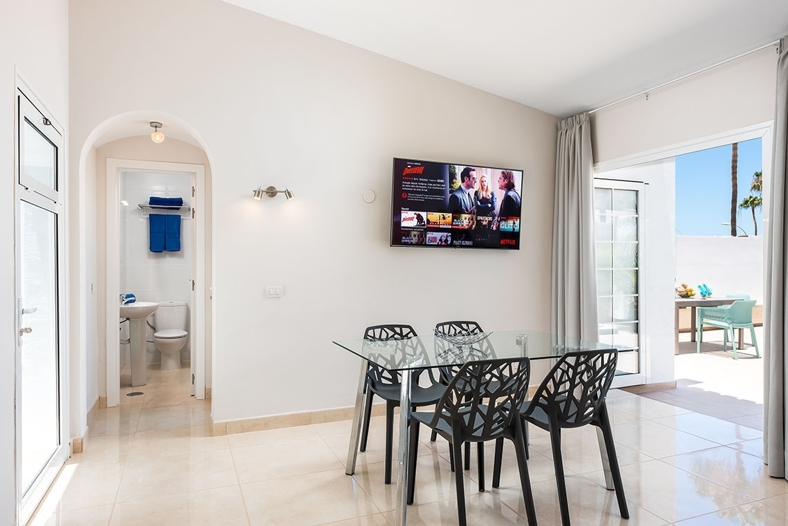 a dining room with a netflix screen above the table