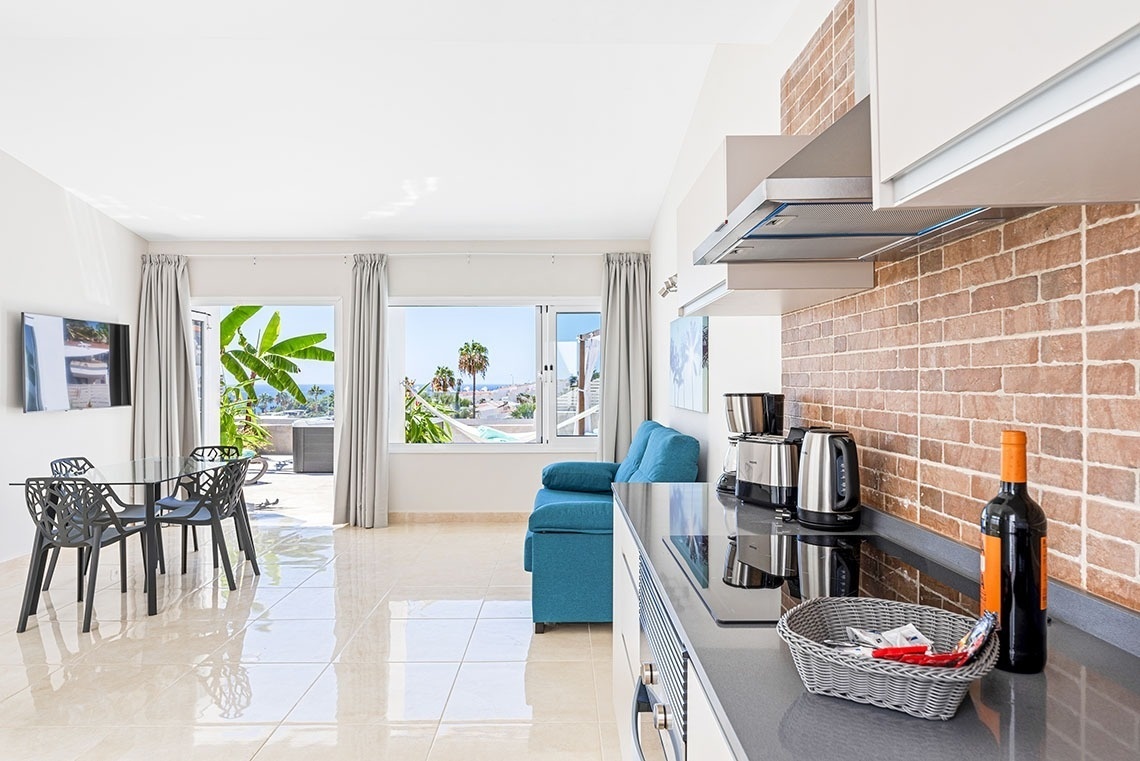 a kitchen with a bottle of wine on the counter