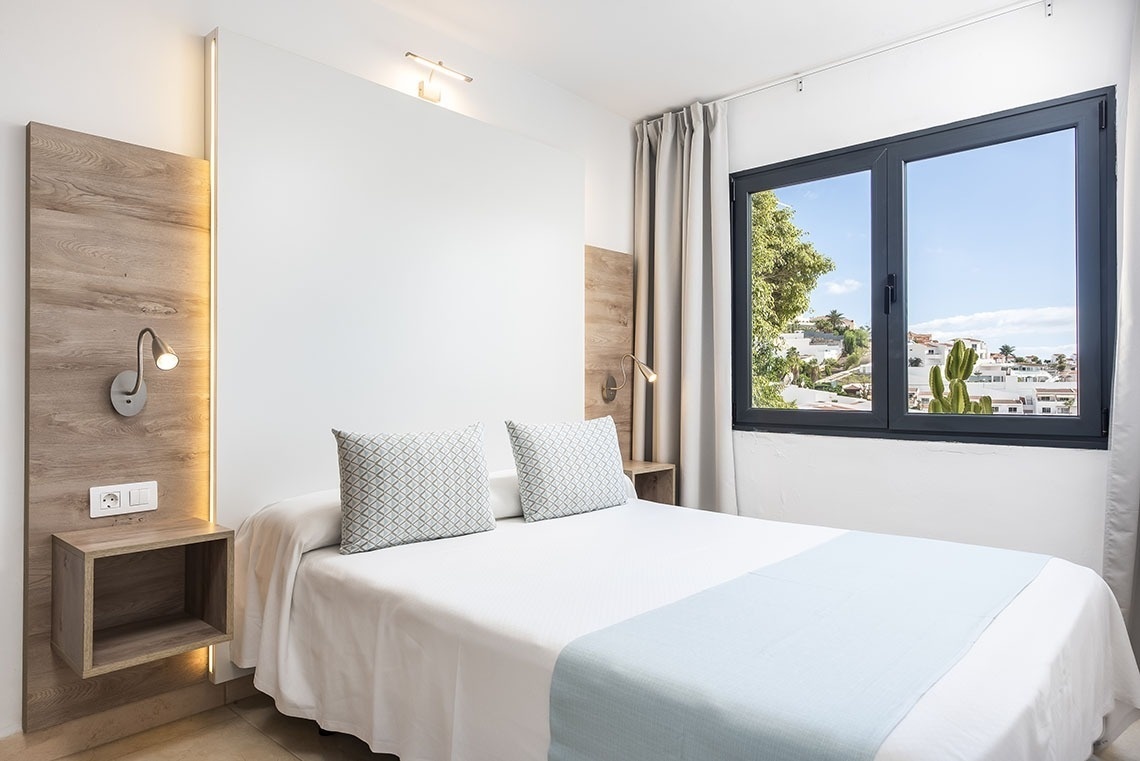 a bedroom with a large bed and a window