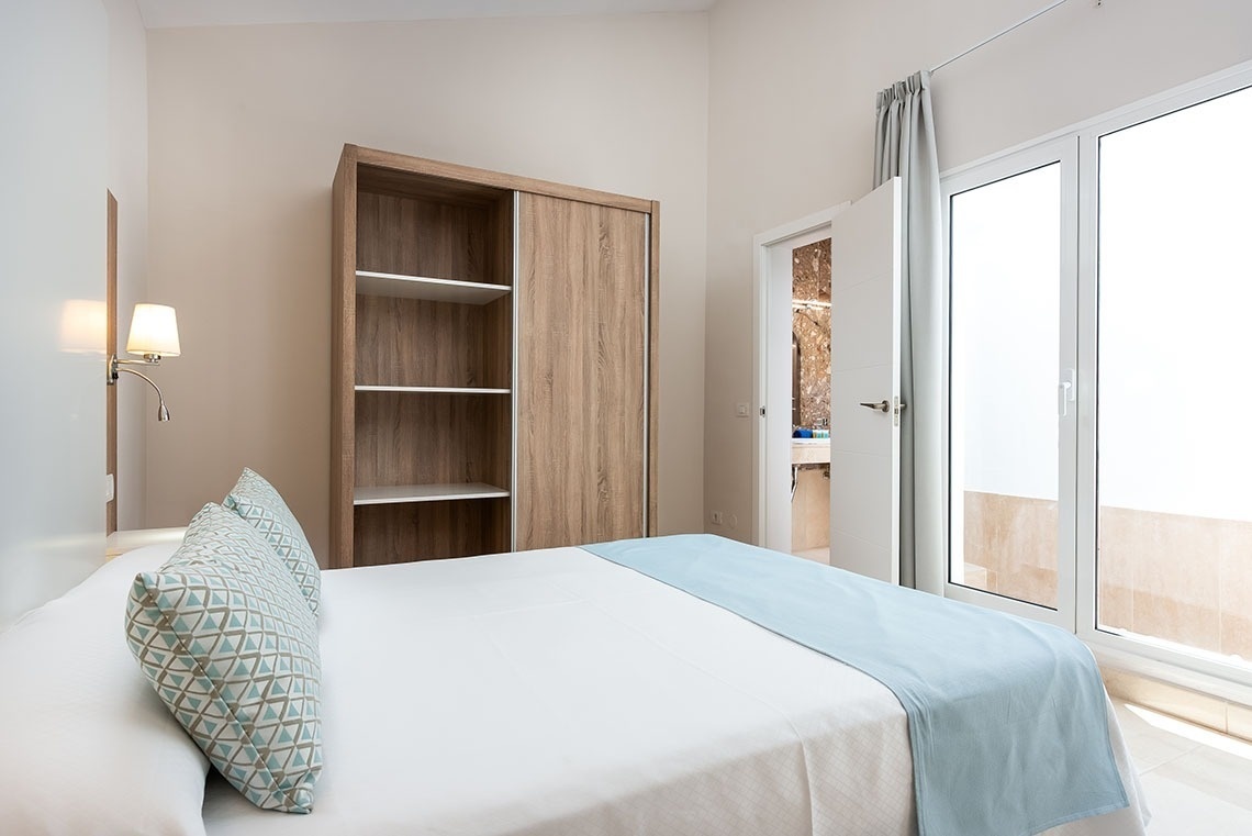 a bedroom with a bed and a sliding glass door