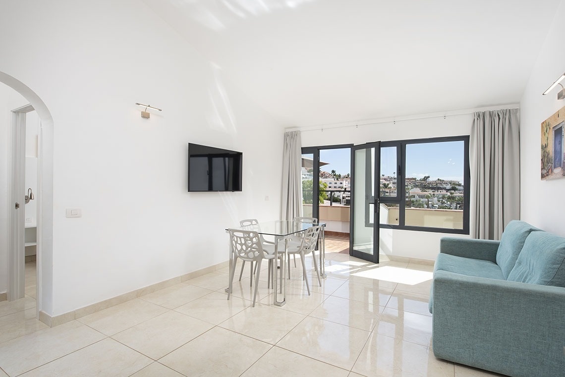 a living room with a couch a table and chairs