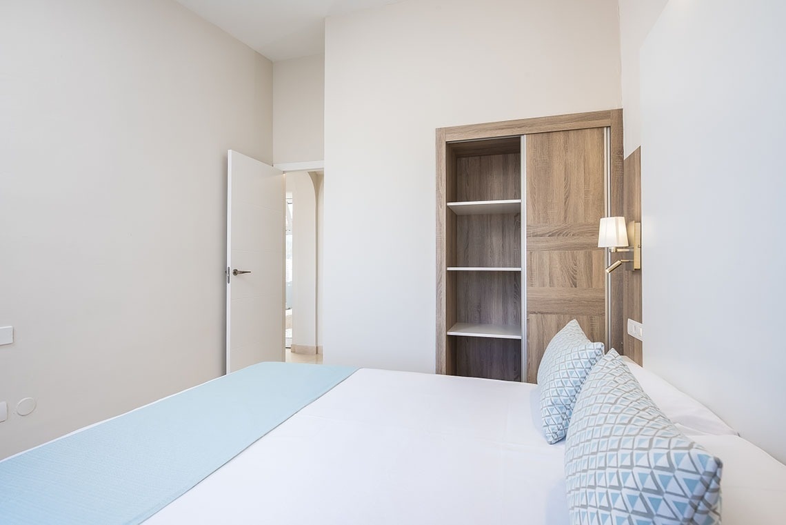 a bedroom with a bed and a closet with shelves