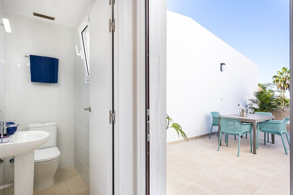 a bathroom with a toilet and a table and chairs