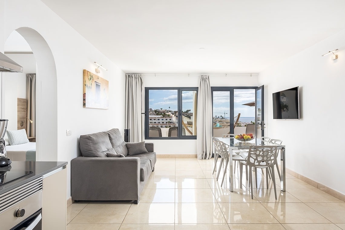 a living room with a couch and a dining table