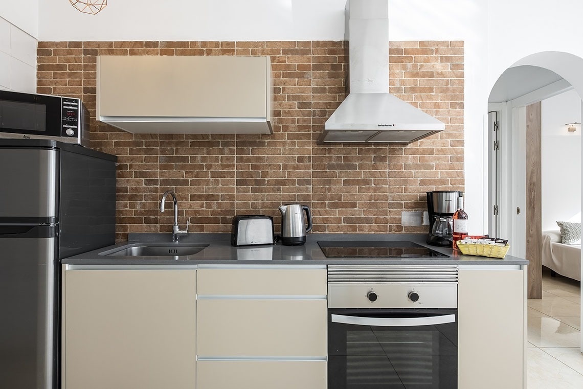 a kitchen with a stove top oven and a microwave