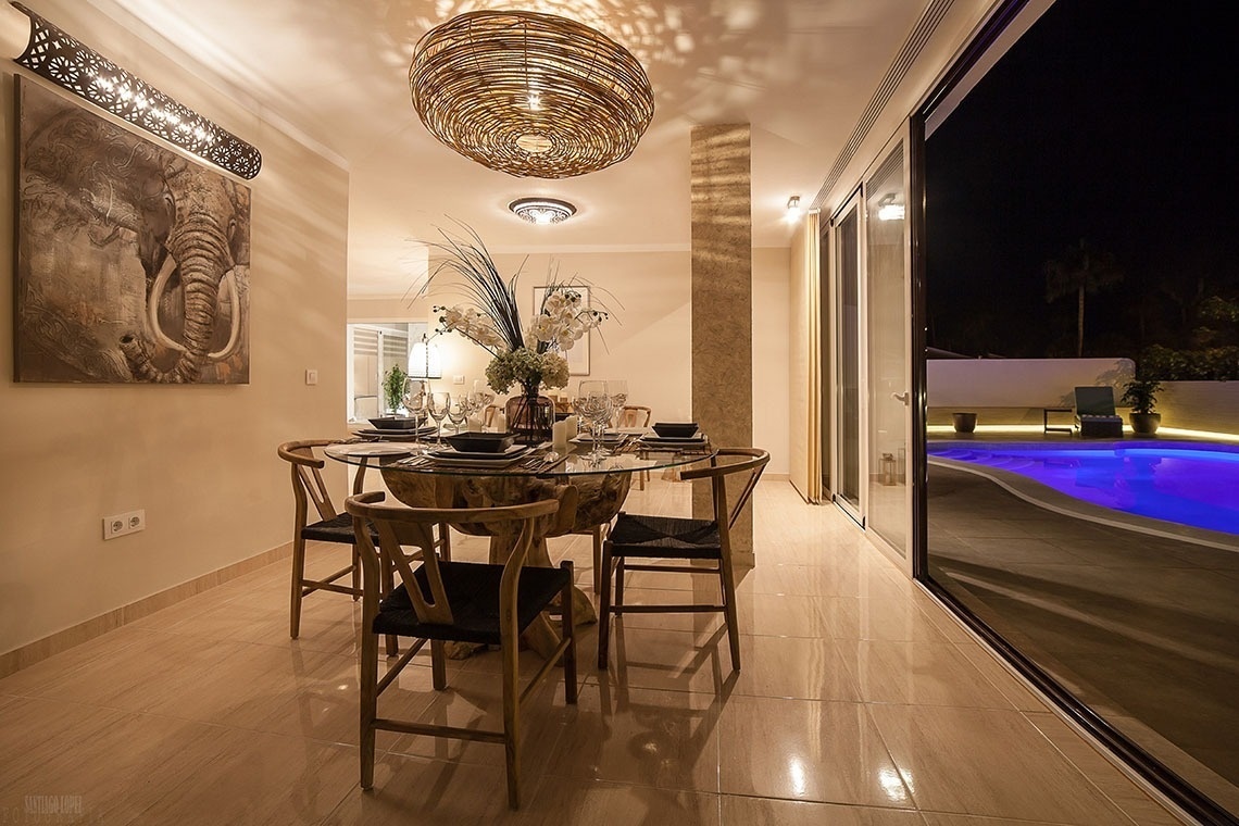a dining room with a painting of an elephant on the wall
