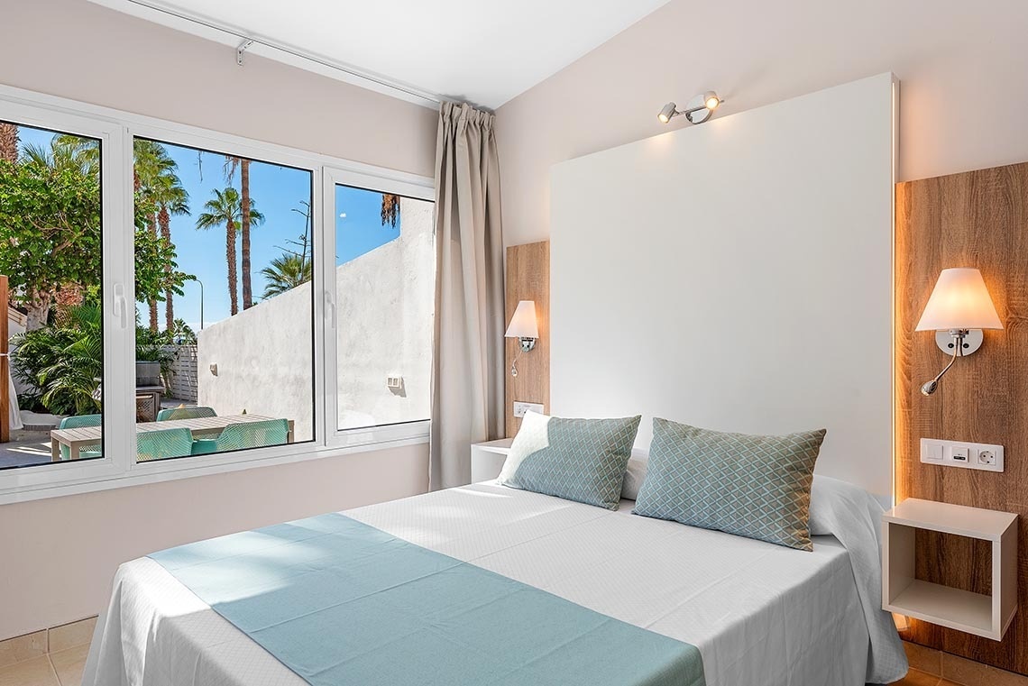 a hotel room with a bed and a window