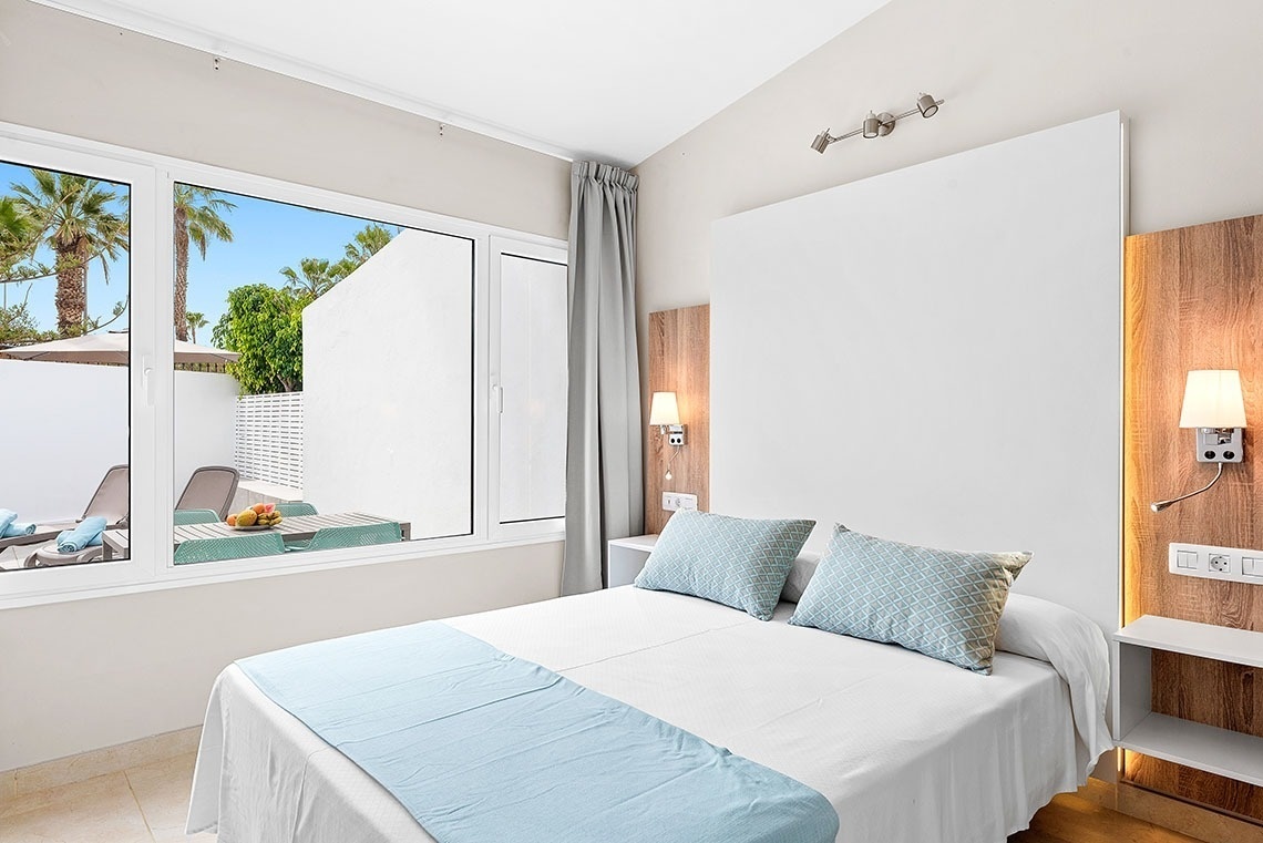 a hotel room with a large bed and a large window