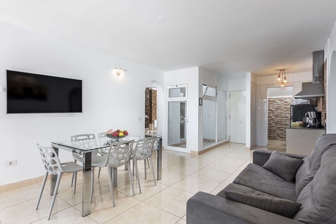 a living room with a couch a table and a flat screen tv