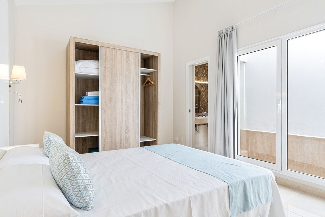 a bedroom with a bed and a sliding glass door