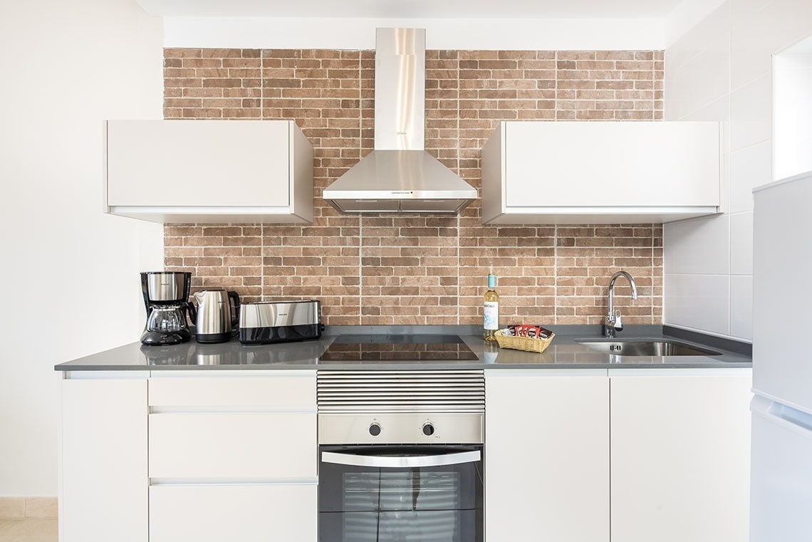 a kitchen with a bottle of wine on the counter