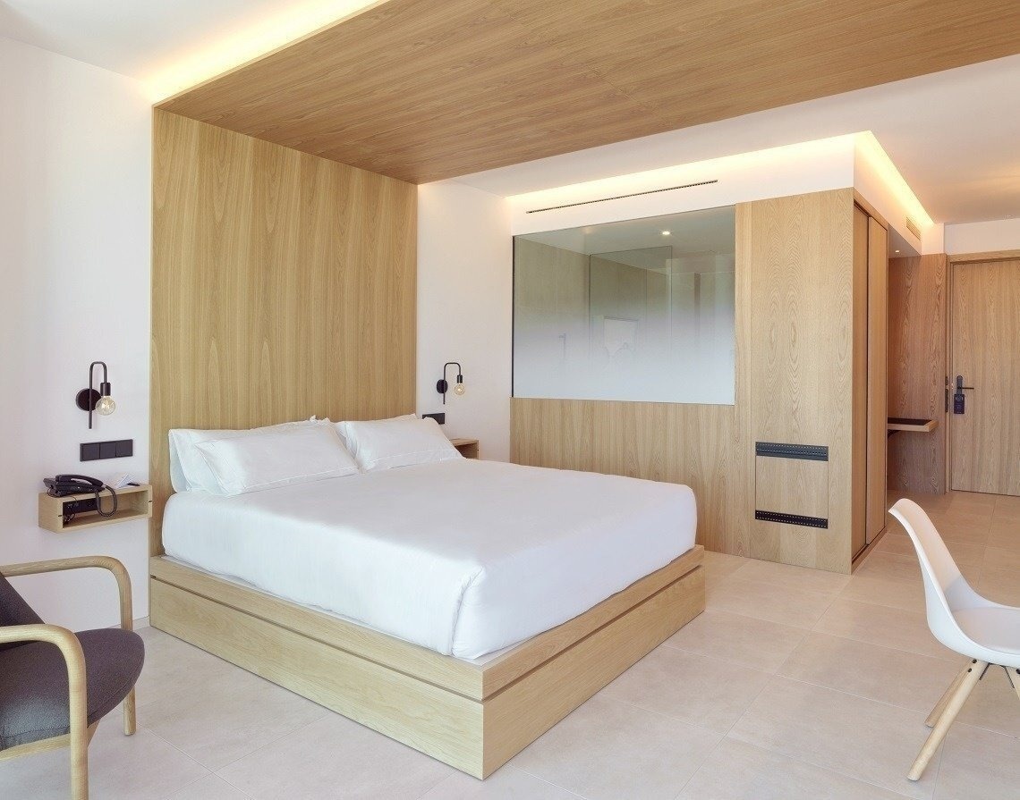 a hotel room with a bed and a chair