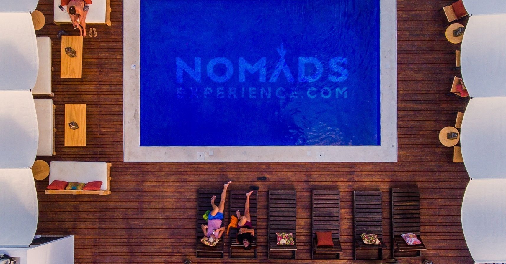 an aerial view of a swimming pool that says nomads experience.com