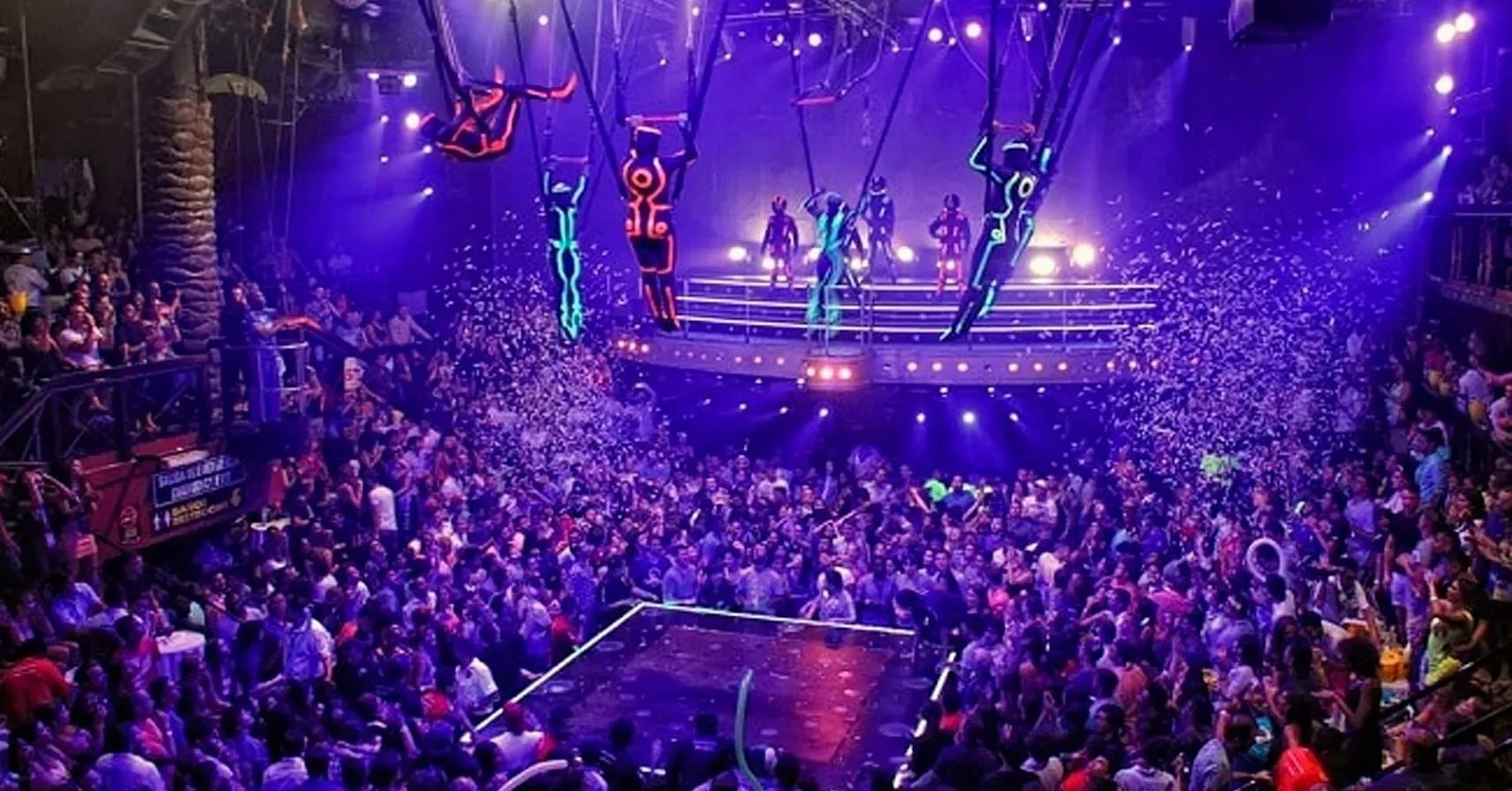 a large crowd of people watching a show at a club