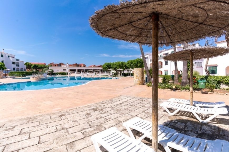 Beach with umbrellas, seats and palm trees of the Hotel Park Royal Beach Acapulco