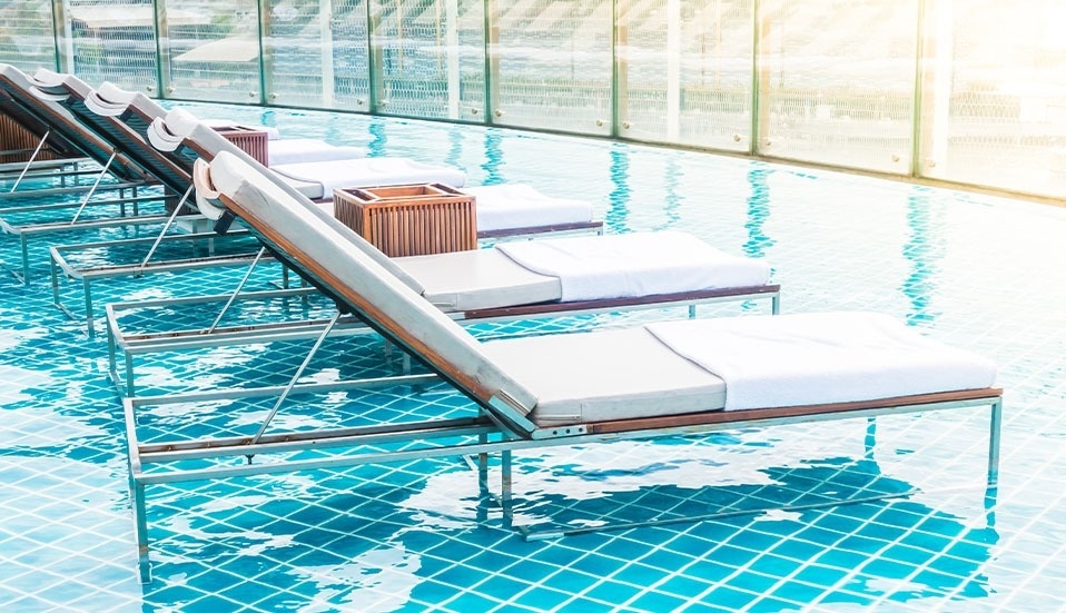 a woman in a bikini stands on a sandy beach near the ocean