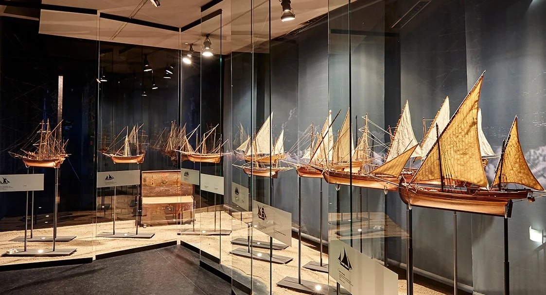 a boy in a yellow life preserver is splashing in a pool