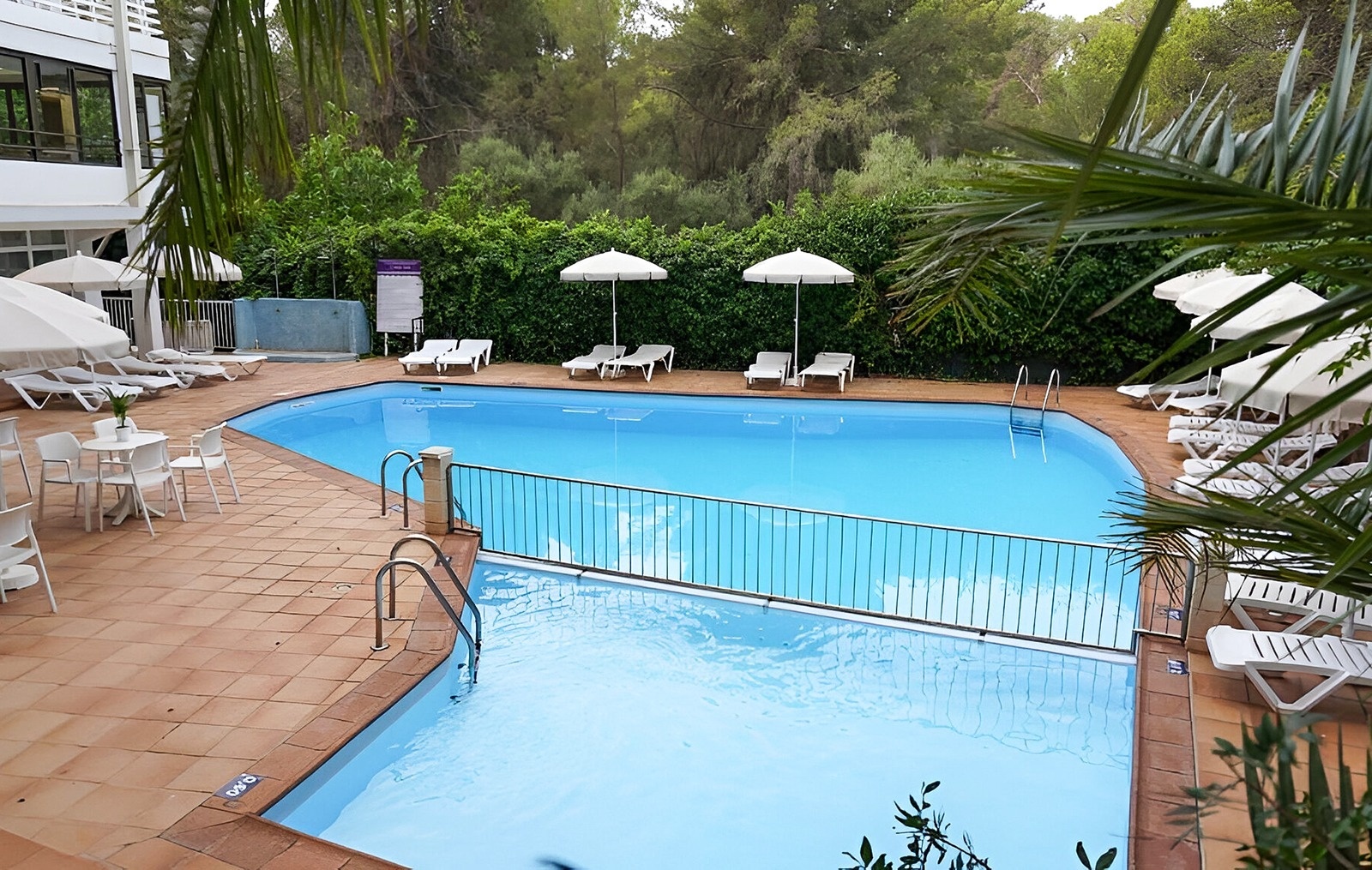 Palm-roofed bar, next to the outdoor pool and sea views at the Park Royal Beach Acapulco Hotel