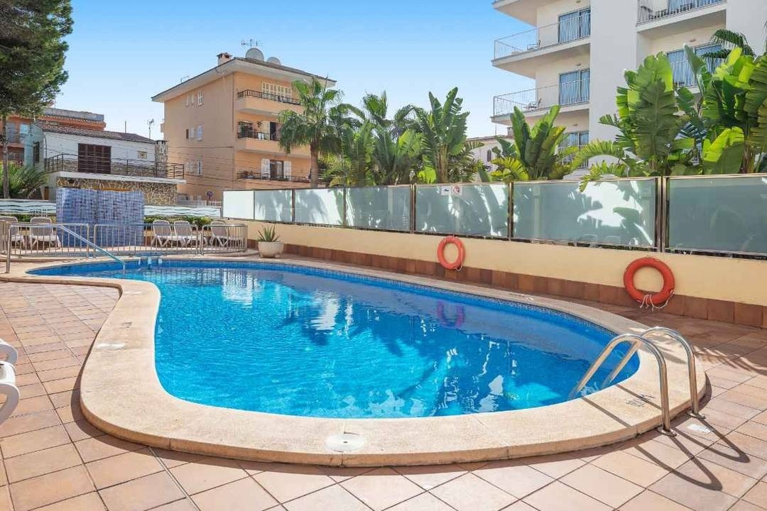Palm-roofed bar, next to the outdoor pool and sea views at the Park Royal Beach Acapulco Hotel