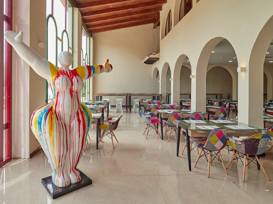 O7 HOTELS: Corporate. Colorful sculpture and dining tables at a hotel.