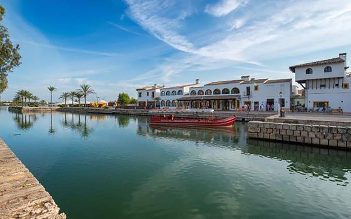 Beach with umbrellas, seats and palm trees of the Hotel Park Royal Beach Acapulco