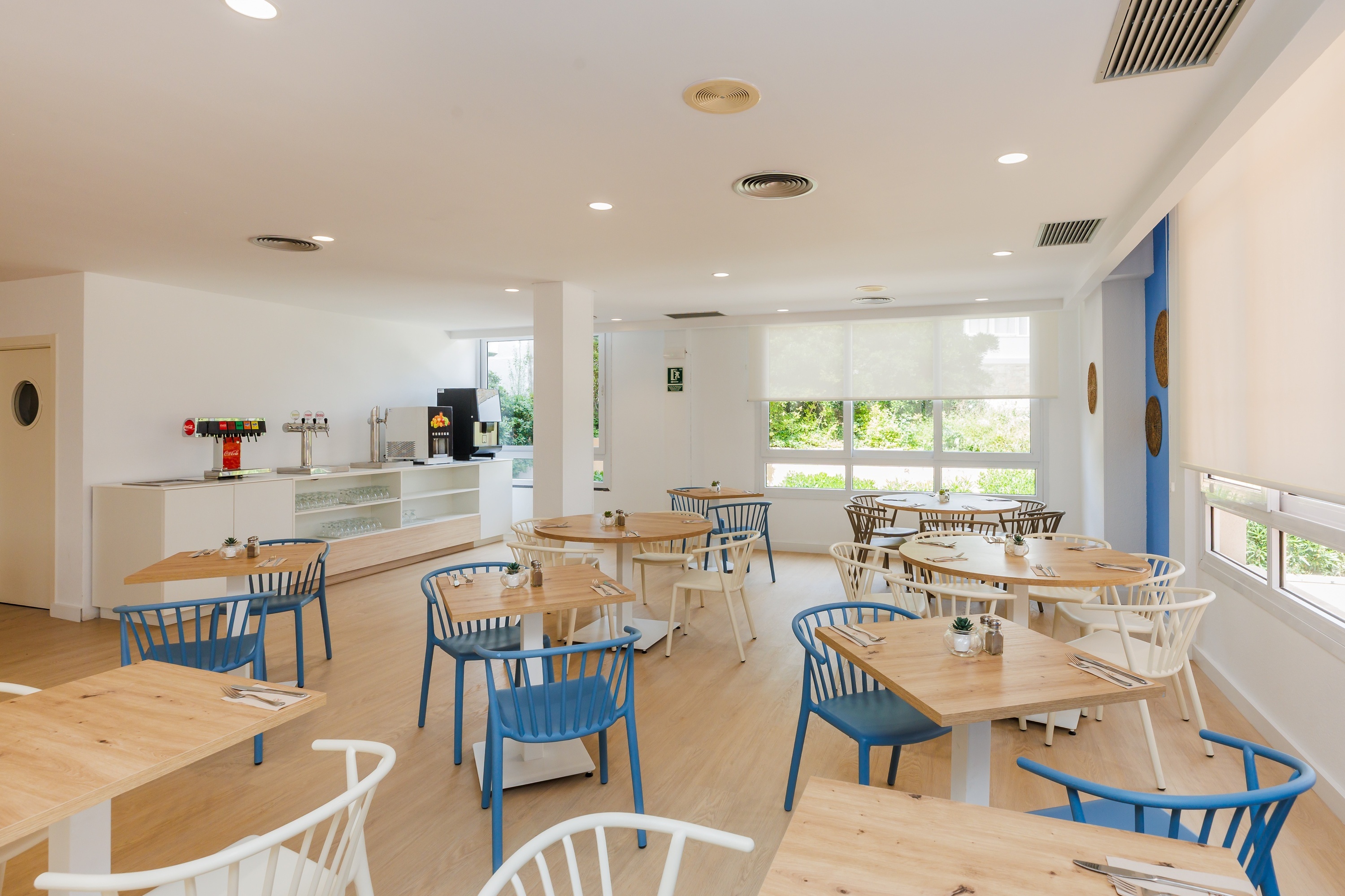 a glass of red liquid with a straw on the beach