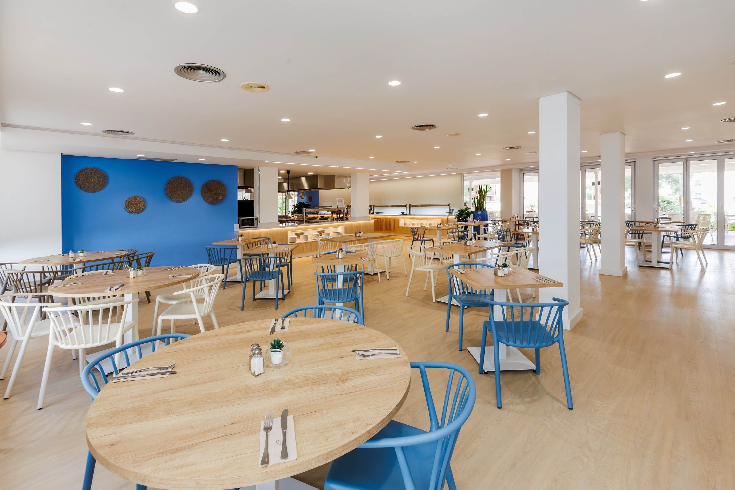 a glass of red liquid with a straw on the beach