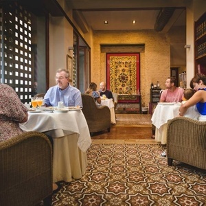 a group of people are sitting at tables in a restaurant