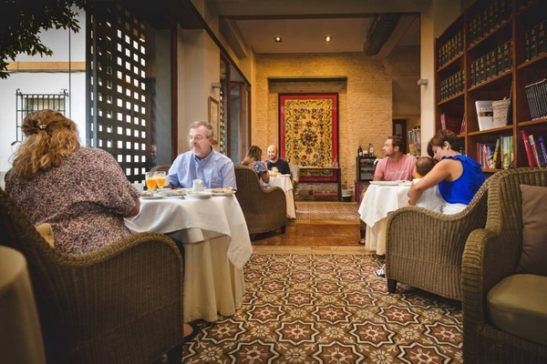 a group of people are sitting at tables in a restaurant