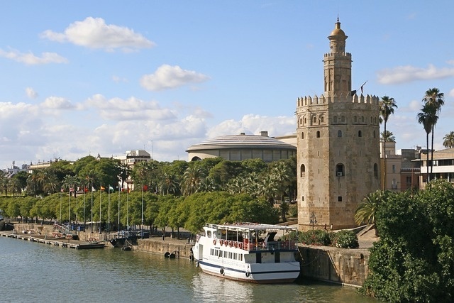 a boat is docked in front of a large tower