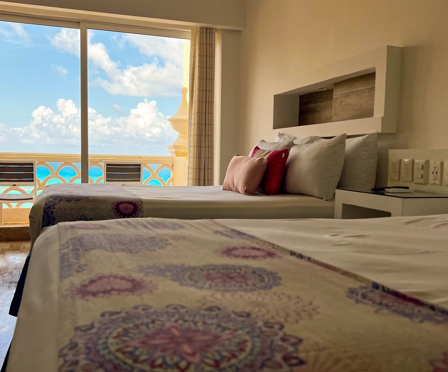 a hotel room with two beds and a large window