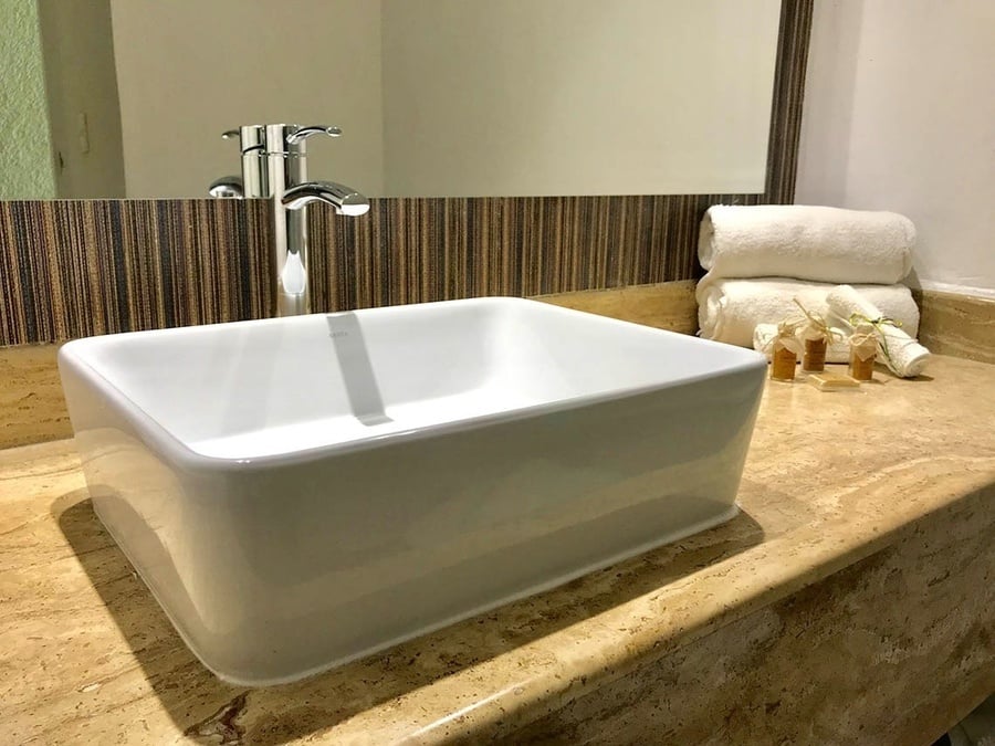 a bathroom counter with a sink and a mirror