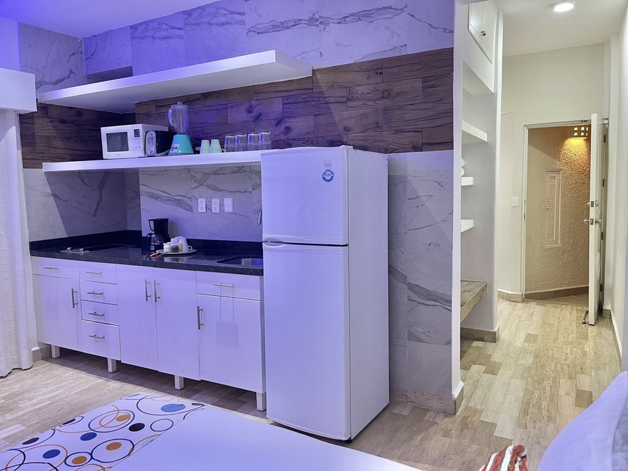 a kitchen with a refrigerator that says ' samsung ' on it